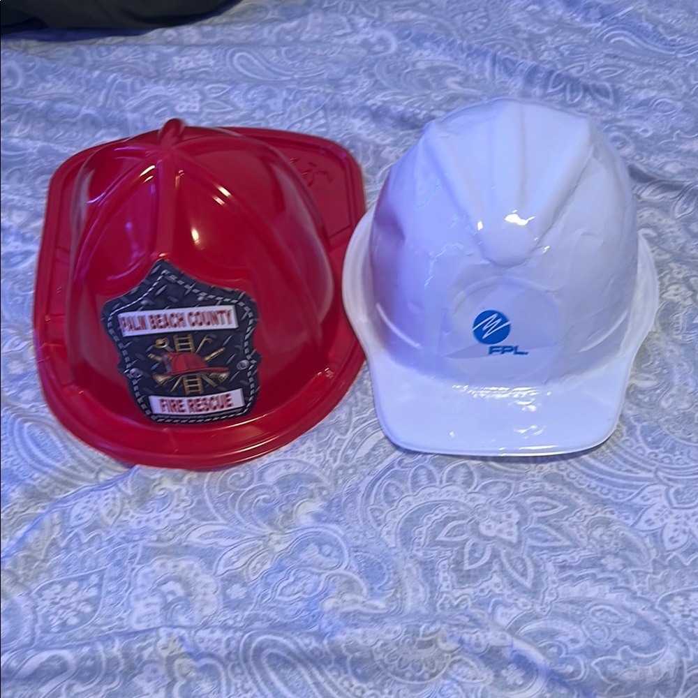 Kids play firefighter and fpl worker hat